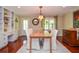 Cozy dining area with hardwood floors, custom built-ins, and natural lighting at 2997 Happy Hollow Se Dr, Conyers, GA 30094
