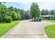 Wide, paved driveway leads to a well-maintained home with mature trees at 2997 Happy Hollow Se Dr, Conyers, GA 30094