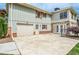 Side exterior showcasing the garage, stone accent wall, and spacious driveway at 2997 Happy Hollow Se Dr, Conyers, GA 30094