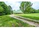 Exterior view of home surrounded by lush greenery and a long driveway at 2997 Happy Hollow Se Dr, Conyers, GA 30094