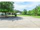 Wide paved driveway leading to the house with barn and treed front yard at 2997 Happy Hollow Se Dr, Conyers, GA 30094