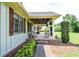 Inviting covered front porch with brick accents, comfortable seating, and a ceiling fan at 2997 Happy Hollow Se Dr, Conyers, GA 30094