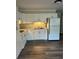 Bright kitchen featuring white cabinetry, laminate countertops and floors, and modern appliances at 2997 Happy Hollow Se Dr, Conyers, GA 30094