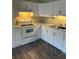 Well-lit kitchen featuring white cabinetry, laminate countertops and floors, and modern appliances at 2997 Happy Hollow Se Dr, Conyers, GA 30094