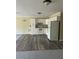 Open floor plan with kitchen featuring white cabinetry, laminate flooring, and modern appliances at 2997 Happy Hollow Se Dr, Conyers, GA 30094