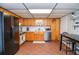 Practical kitchen with wood cabinets, stainless steel dishwasher, and eat-in area at 2997 Happy Hollow Se Dr, Conyers, GA 30094