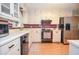White kitchen with appliances including stainless steel refrigerator and black dishwasher at 2997 Happy Hollow Se Dr, Conyers, GA 30094