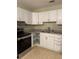 Galley kitchen featuring white cabinets, stainless steel appliances, and neutral countertops at 2997 Happy Hollow Se Dr, Conyers, GA 30094