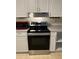 Modern kitchen with stainless steel range and white cabinets at 2997 Happy Hollow Se Dr, Conyers, GA 30094