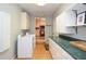 Laundry room with green countertops, abundant storage, and modern washer and dryer at 2997 Happy Hollow Se Dr, Conyers, GA 30094