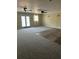Spacious living room with neutral carpet, doors leading to deck, and ample natural light at 2997 Happy Hollow Se Dr, Conyers, GA 30094