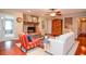Cozy living room showcasing a stone fireplace, hardwood floors, and comfortable seating at 2997 Happy Hollow Se Dr, Conyers, GA 30094
