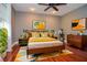 This main bedroom features a queen bed, ceiling fan, bedside tables, and a mid-century modern decor at 2997 Happy Hollow Se Dr, Conyers, GA 30094