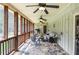 This covered porch features slate floors, multiple ceiling fans, and wooden railings at 2997 Happy Hollow Se Dr, Conyers, GA 30094