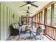 This covered porch features slate floors, multiple ceiling fans, and wooden railings at 2997 Happy Hollow Se Dr, Conyers, GA 30094