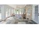 Sunroom with slate tile, stone wall, French doors offer abundant light and pool views at 2997 Happy Hollow Se Dr, Conyers, GA 30094