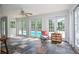 Bright sunroom with slate floors, ceiling fan, and pool view through large glass doors at 2997 Happy Hollow Se Dr, Conyers, GA 30094