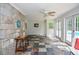 Sunroom with slate tile floors, stone accent wall, and French doors opening to the pool at 2997 Happy Hollow Se Dr, Conyers, GA 30094
