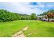 Expansive front yard with lush greenery, offering a serene view of the home and surrounding landscape at 2997 Happy Hollow Se Dr, Conyers, GA 30094