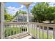 Balcony view overlooking manicured lawns, trees, and other condo buildings at 403 Abingdon Way, Atlanta, GA 30328