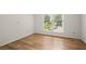 Bright bedroom with hardwood floors and a large window overlooking the neighborhood at 403 Abingdon Way, Atlanta, GA 30328