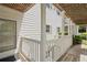 View of condo exterior showing the wooden porch and white railings plus the front door at 403 Abingdon Way, Atlanta, GA 30328