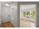 Bright foyer with hardwood floors, white walls, and decorative glass in a front window at 403 Abingdon Way, Atlanta, GA 30328