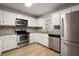 Bright kitchen featuring stainless steel appliances, white cabinets, and granite countertops at 403 Abingdon Way, Atlanta, GA 30328