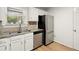Updated kitchen boasts stainless steel appliances, white cabinetry and plenty of natural light at 403 Abingdon Way, Atlanta, GA 30328