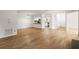 Open concept living space featuring hardwood floors and view into kitchen at 403 Abingdon Way, Atlanta, GA 30328