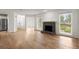 Open living room with hardwood floors, fireplace, and view of the front yard at 403 Abingdon Way, Atlanta, GA 30328
