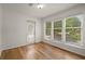 Sunroom features hardwood floors and large windows for natural light, plus access to balcony at 403 Abingdon Way, Atlanta, GA 30328