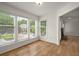 Sunroom featuring hardwood floors, bright white walls, and large windows overlooking the street at 403 Abingdon Way, Atlanta, GA 30328
