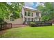 Exterior showing the back of the house, the deck, and a grill with large trees in the background at 503 Kensington Estates Trce, Woodstock, GA 30188