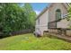 Backyard with grassy lawn and landscaping featuring trees, plants and bushes at 503 Kensington Estates Trce, Woodstock, GA 30188