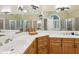 Bright bathroom with double vanity, wood cabinets, large mirrors, and separate tiled shower at 503 Kensington Estates Trce, Woodstock, GA 30188
