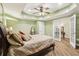 Bright bedroom with a ceiling fan, hardwood floors, and French doors at 503 Kensington Estates Trce, Woodstock, GA 30188