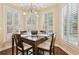 Bright breakfast nook with a wooden table and shuttered windows with natural lighting at 503 Kensington Estates Trce, Woodstock, GA 30188