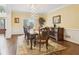 Elegant dining room with hardwood floors, decorative rug, and stylish buffet at 503 Kensington Estates Trce, Woodstock, GA 30188