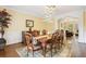 Formal dining room featuring hardwood floors, stylish chandelier, and elegant furnishings at 503 Kensington Estates Trce, Woodstock, GA 30188