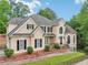 Charming home with a landscaped front yard, featuring a mix of stone and stucco at 503 Kensington Estates Trce, Woodstock, GA 30188