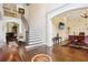 Open foyer with hardwood floors, staircase, and views into the living spaces at 503 Kensington Estates Trce, Woodstock, GA 30188