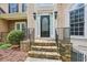 Elegant front door entrance with stone steps and decorative iron railings at 503 Kensington Estates Trce, Woodstock, GA 30188