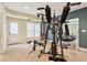Spacious home gym featuring equipment and a seating area with natural light at 503 Kensington Estates Trce, Woodstock, GA 30188