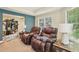 Sitting and exercise area with large recliners and equipment, ideal for relaxation and fitness at 503 Kensington Estates Trce, Woodstock, GA 30188
