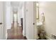 Arched hallway showcasing hardwood floors, leading to powder room at 503 Kensington Estates Trce, Woodstock, GA 30188