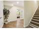 Bright hallway with hardwood floors leads to a bedroom, with stairs visible to the right at 503 Kensington Estates Trce, Woodstock, GA 30188