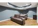 Home theater features a projector, comfortable seating, and moody lighting at 503 Kensington Estates Trce, Woodstock, GA 30188