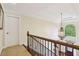 Elegant landing with a decorative chandelier and a large arched window, offering a view of the outdoors at 503 Kensington Estates Trce, Woodstock, GA 30188