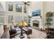 Inviting living room with a stone fireplace and large windows that provide ample light at 503 Kensington Estates Trce, Woodstock, GA 30188